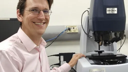 Tevis leaning on lab equipment.